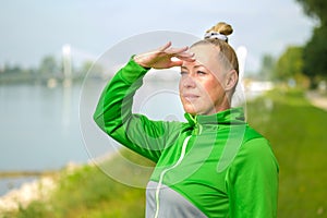 Attractive blond middle-aged woman lookig off into the distance