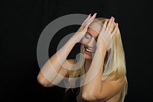 Attractive blond model on black background