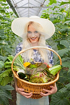 Attractive blond woman with a basket of vegetables
