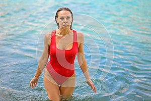 Attractive blond woman rising out of the water