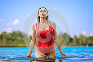 Attractive blond woman rising out of the water