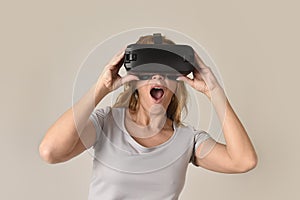 Attractive blond woman wearing headset VR virtual reality vision goggles watching video