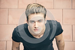 Attractive blond young man shot from above, looking up