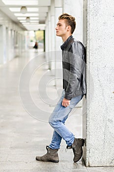 Attractive blond young man standing outside