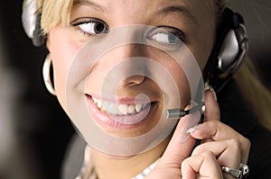 Attractive blonde businesswoman with headphone