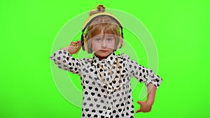 Attractive blonde child kid listening music via headphones dancing disco fooling having fun party