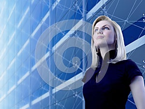 Attractive blonde standing by the skyscraper