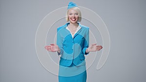 Attractive blonde stewardess holding safety instruction