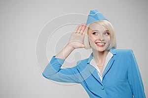 Attractive blonde stewardess overhear on empty space.