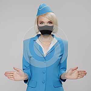 Attractive blonde stewardess in protective mask holds safety instructions