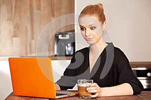 Attractive blonde student girl working on personal computer