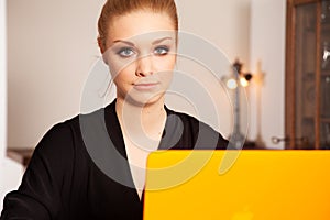 Attractive blonde student girl working on personal computer