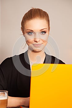 Attractive blonde student girl working on personal computer