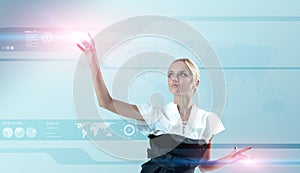 Attractive blonde touching the virtual interface