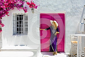 Woman in front of a traditional cylcadic house in Paros, Greece photo