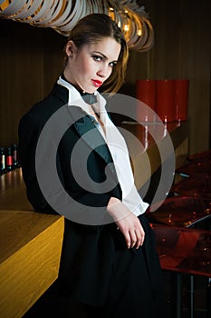 Attractive blonde woman dressed in a tuxedo in a pub