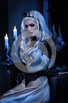Attractive blonde woman in fantasy costume of dark queen