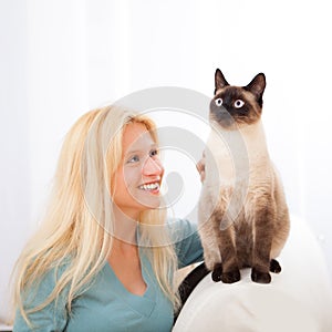 Attractive blonde woman having good times with cat