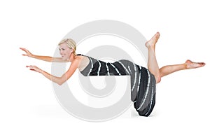 Attractive blonde woman lying on white block