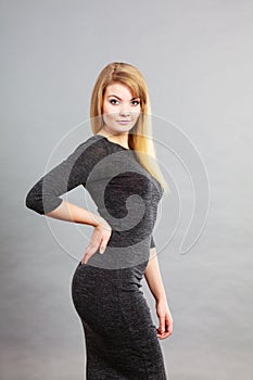 Attractive blonde woman wearing tight black dress