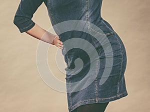 Attractive blonde woman wearing tight jeans dress