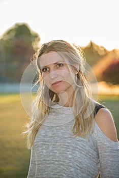 Attractive blonde young woman in a park