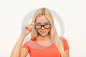 Attractive brainy young woman touching her eyewear