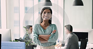 Attractive Brazilian businesswoman posing in coworking office