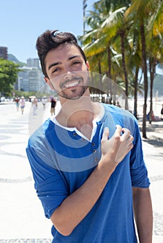 Attractive brazilian guy standing at Aveniada Atlantica at Rio de Janeiro photo