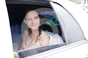 Attractive bride in a car