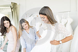 Attractive Bride Choosing A Wedding Dress In The Store
