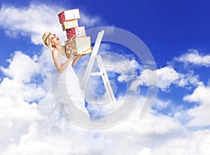 Attractive bride holding a bunch of presents - heaven concept
