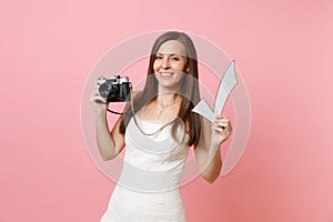 Attractive bride woman in wedding dress holding retro vintage photo camera and check mark, choosing staff, photographer