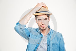 Attractive bristled young man in blue shirt and hat photo