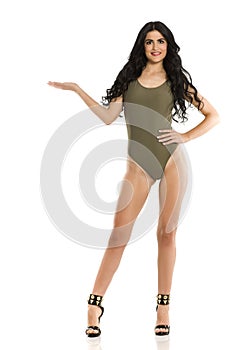 Attractive brunette advertizing in one piece swimsuit photo