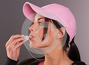 Attractive Brunette Female Blows Whistle Pink Ball Cap Whistle