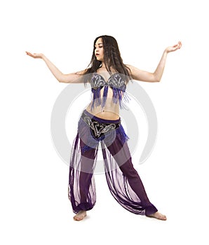 Attractive brunette girl with long hair dancing belly dance.