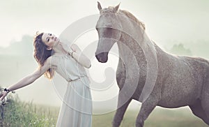 Attractive brunette lady and spotted horse