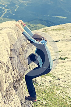 Attractive brunette rock climbing.