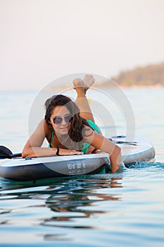 Attractive brunette on stand up paddle board