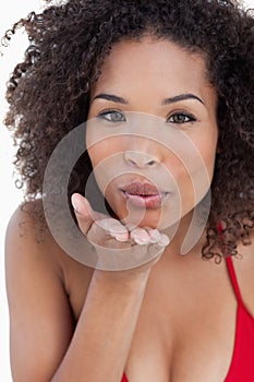 Attractive brunette woman sending an air kiss