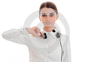 Attractive brunette woman working in call center with headphones and microphone and looking at the camera isolated on