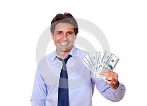 Attractive business man holding up cash dollars