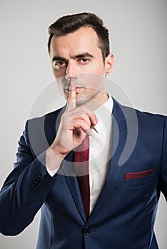 Attractive business man making sush gesture with finger