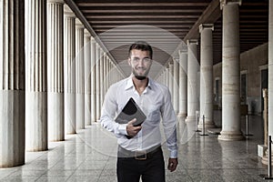 Attractive business man with a notebook in his hand