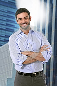 Attractive business man posing happy in corporate portrait outdoors on financial district