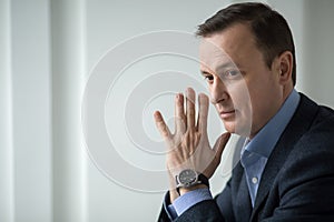 Attractive business man sitting pensively looking