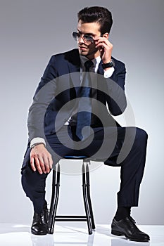 Attractive business man sitting on a stool