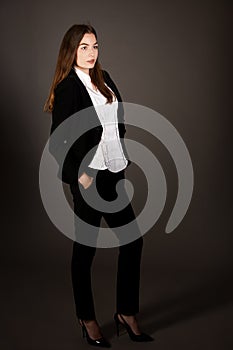 Attractive business woman - full length corporative portrait islated over gray background photo
