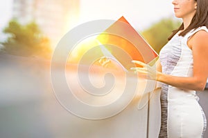 Attractive business woman reads  real file outside, concept moden women working in business